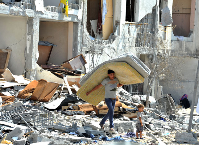 Palestinian Searches Through Rubble in Towers Al-andaa, Gaza