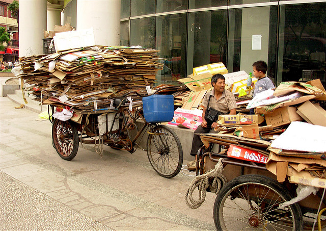 Man sits with his freight bike of recyclabel materials