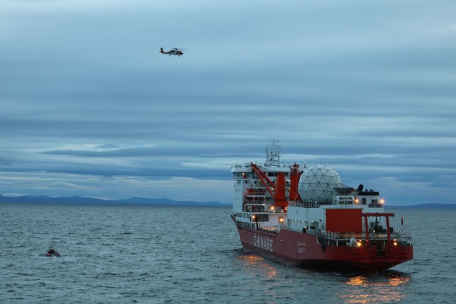 A smallboat crew from the Coast Guard Cutter Alex Haley medevacs a man suffering a broken arm from the Chinese research vessel Xue Long, 15 nautical miles from Nome, Alaska, Sept. 23, 2017. The smallboat crew embarked the man and transferred him to the Alex Haley for further transfer to Nome, Alaska. U.S. Coast Guard photo.