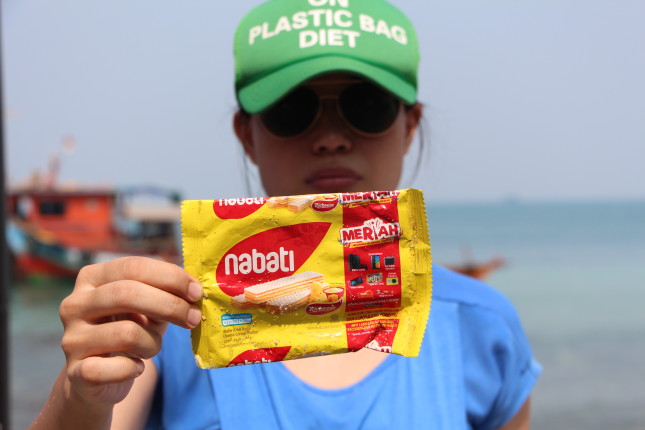 Tiza holding a plastic package