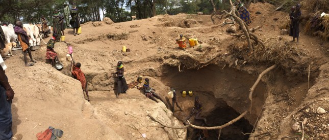 Turkana women extracting water in Northern Karamoja. These holes, which are roughly 20 feet deep and 20 feet across are hand-dug every dry season and fill in during the rainy season. Photo credit: Daniel Abrahams