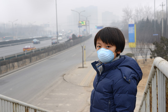 A boy standing with smog