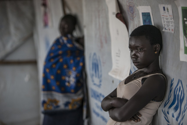 A young South Sudanese girl strikes a thoughtful look while taking shelter from rain at Bidibidi refugee settlement in Yumbe district, located in northwestern Uganda on August 29, 2017. EU/ECHO/Edward Echwalu