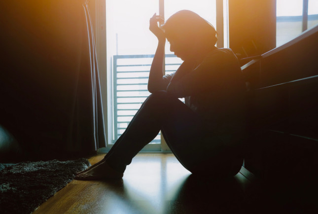 Asian,Woman,Sit,On,The,Floor,Beside,Window,In,Dark