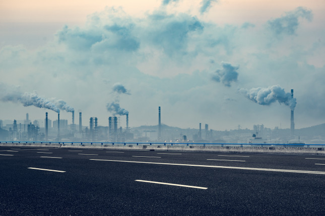 Industrial,Factory,With,Smoking,Chimneys,Against,Cloudy,Sky,shanghai,china.