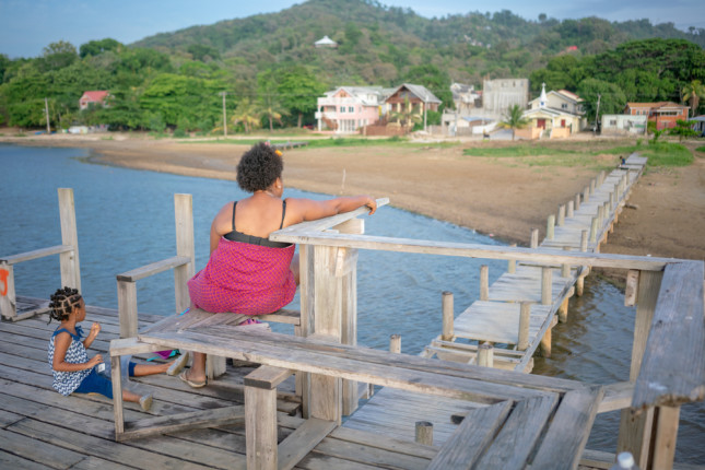 Garifuna,Family,/,Mother,&,Daughter,On,Ocean,Pier,In
