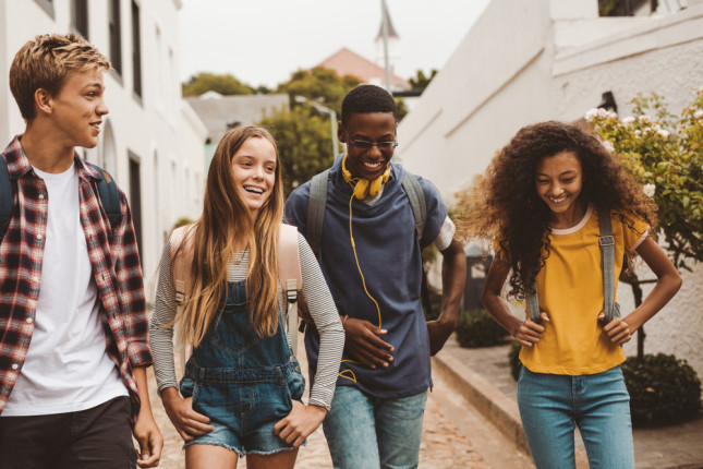 Group,Of,Multiethnic,College,Friends,Walking,In,The,Street.,Smiling