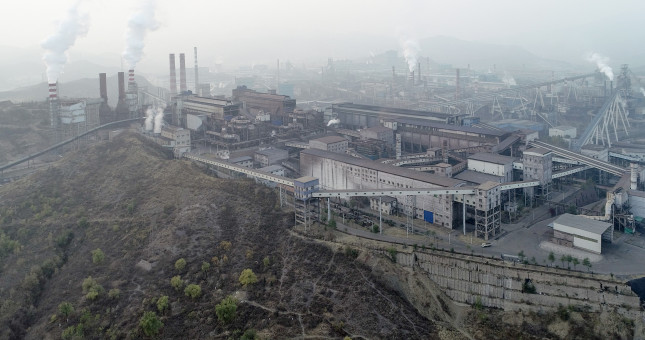 Aerial view of big factory in China.Air pollution by smoke coming out of chimneys
