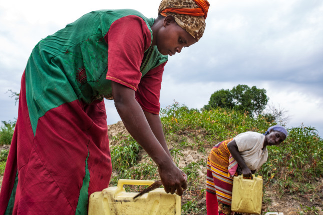 BULENZI VILLAGE, LWABENGE SUB-COUNTY, KALUNGU DISTRICT, UGANDA: March 26, 2019 - Justine Nitele, 36, fetches water, a task that was difficult and embarassing to undertake before fistula repair surgery.  Justine is a mother of seven and a fistula survivor. Justine got fistula during a problematic labor of her fifth child. She suffered from the condition for three years. She was informed of treatment for fistula by a midwife. Justine attended Kitovu Hospital in 2014 to have treatment under the USAID Fistula Care Plus program. Justine has recovered completely and is now proudly raising awareness of fistula and its dangers as well as how to prevent it amongst the community. Photo by: Carielle Doe