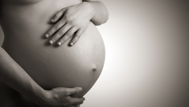 Belly,Of,Pregnant,Woman,Monochrome,On,A,Dark,Background