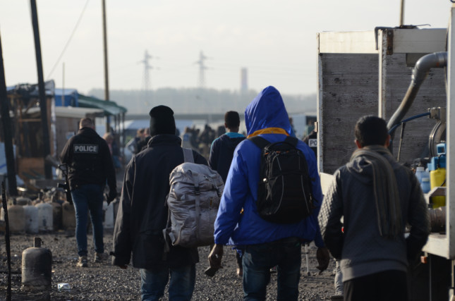 The,Jungle,,Calais,,France.,10/28/16,A,Group,Of,Migrants,Leave