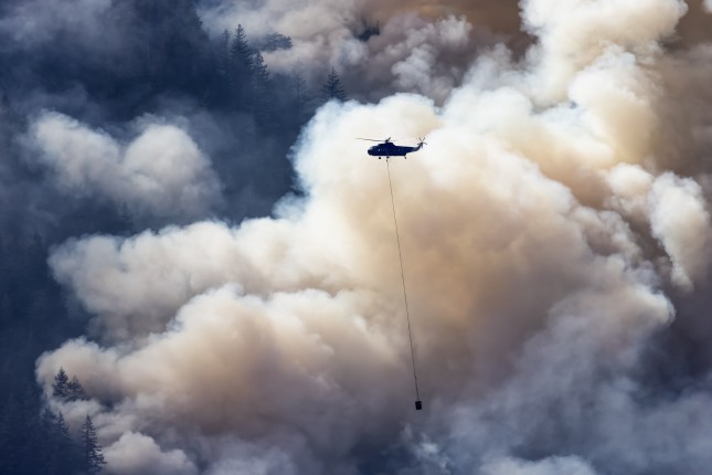 Wildfire,Service,Helicopter,Flying,Over,Bc,Forest,Fire,And,Smoke