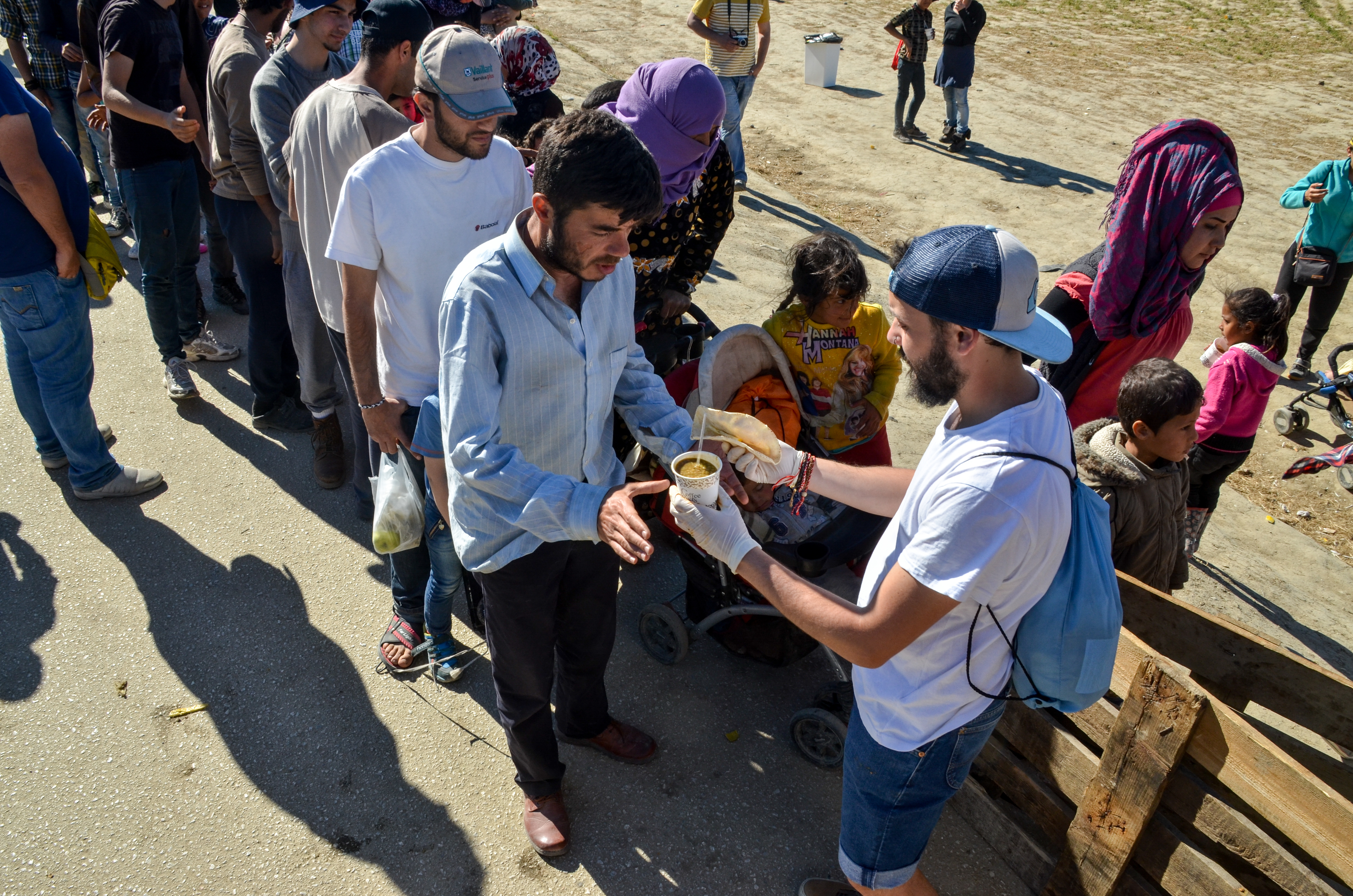 A refugee waiting in line for food